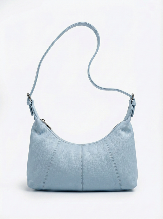 Light blue handbag with a strap on a white background
